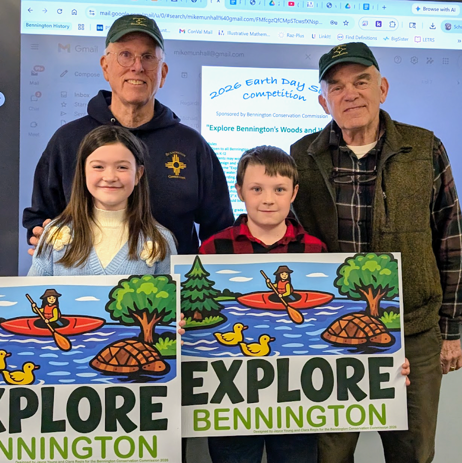 Students hold up road sign they designed for the contest.